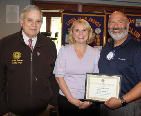 ‘A Certificate of Appreciation’ was given to guest speaker Lindsay Vanderbilt following her presentation April 10 during the weekly luncheon of the Canton Lions Club at the Van Zandt Country Club. Vanderbilt is the East Texas Council of Governments (ETCOG) Director of Communications. Standing with Vanderbilt were Canton Lions Club President Jesse Carranza, far right, and Van Zandt County Judge and Canton Lions Club member Andy Reese. Photo by David Barber
